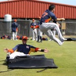 Houston Astros infielder Jose Altuve, right, leaps up and over a sliding outfielder J.D. Martinez during a second-base drill at baseball spring training Tuesday, Feb. 19, 2013, in Kissimmee, Fla. (AP Photo/Houston Chronicle, Karen Warren)