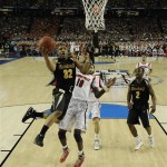 Wichita State's Tekele Cotton (32) heads to the hoop under the defense of Louisville's Gorgui Dieng (10) during the second half of the NCAA Final Four tournament college basketball semifinal game Saturday, April 6, 2013, in Atlanta. (AP Photo/NCAA Photos, Chris Steppig)
