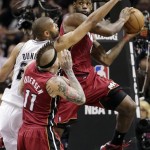 Miami Heat's LeBron James looks to pass around San Antonio Spurs' Tim Duncan as Chris Andersen (11) reacts during the first half at Game 3 of the NBA Finals basketball series, Tuesday, June 11, 2013, in San Antonio. (AP Photo/Eric Gay)