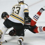 Chicago Blackhawks left wing Bryan Bickell (29) hits the ice while trying to score against Boston Bruins defenseman Zdeno Chara (33) in the first period during Game 5 of the NHL hockey Stanley Cup Finals, Saturday, June 22, 2013, in Chicago. (AP Photo/Nam Y. Huh)
