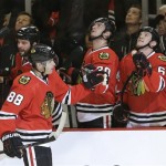 Chicago Blackhawks right wing Patrick Kane (88) celebrates his goal with teammates during the first period of an NHL hockey game against the Washington Capitals on Tuesday, Oct. 1, 2013, in Chicago. (AP Photo/Nam Y. Huh)
