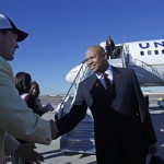 Stanford coach David Shaw, center, is greeted by Fiesta Bowl board member Brian Hall, left, upon arrival to play Oklahoma State in the Fiesta Bowl college football game Monday, Dec. 26, 2011at Sky Harbor International Airport in Phoenix. (AP Photo/Paul Connors)