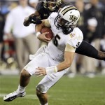 Central Florida quarterback Blake Bortles (5) is tackled by Baylor safety Ahmad Dixon during the second half of the Fiesta Bowl NCAA college football game, Wednesday, Jan. 1, 2014, in Glendale, Ariz. (AP Photo/Rick Scuteri)