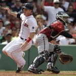 Boston Red Sox's Stephen Drew, left, scores on a single by Red Sox's Shane Victorino as Arizona Diamondbacks catcher Tuffy Gosewisch, right, waits for the ball in the sixth inning of a baseball game at Fenway Park in Boston, Sunday, Aug. 4, 2013. (AP Photo/Steven Senne)
