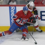 Ottawa Senators' Daniel Alfredsson (11) and Montreal Canadiens' Travis Moen fight for the puck during second-period NHL hockey Game 2 first-round playoff action in Montreal, Friday, May 3, 2013. (AP Photo/The Canadian Press, Graham Hughes)