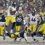 
Pittsburgh Steelers' Le'Veon Bell (26) leaps over Green Bay Packers' Morgan Burnett during the second half of an NFL football game Sunday, Dec. 22, 2013, in Green Bay, Wis. (AP Photo/Mike Roemer)