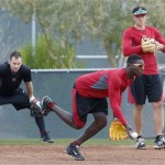 Arizona Diamondbacks' Didi Gregorius, front, tosses the ball to second base, as teammates Chris Owings, left, and Nick Ahmed watch as the players have an informal practice a day prior to pitchers and catchers practicing for the first day of baseball spring training, at the Diamondbacks' facility Thursday, Feb. 6, 2014, in Scottsdale, Ariz. (AP Photo/Ross D. Franklin)