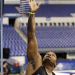 Missouri defensive lineman Michael Sam reaches during a vertical jump test at the NFL football scouting combine in Indianapolis, Monday, Feb. 24, 2014. (AP Photo/Nam Y. Huh)