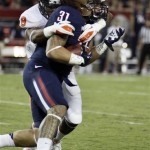Arizona's Taimi Tutogi (31) is tackled by Oregon State's Tyrequek Zimmerman (8) during the first quarter of an NCAA college football game at Arizona Stadium in Tucson, Ariz., Saturday, Sept. 29, 2012. (AP Photo/Wily Low)