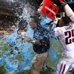 Arizona head coach Tim Kish, left, gets Gatorade dumped on him by players Ka'Deem Carey (25) and Lamar De Rego (93) after defeating Arizona State in an NCAA college football game Saturday, Nov. 19, 2011, in Tempe, Ariz. Arizona defeated Arizona State 31-27. (AP Photo/Ross D. Franklin)