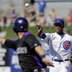 Chicago Cubs' Starlin Castro, right, throws to first as Colorado Rockies' Ramon Hernandez is caught in a rundown during an exhibition spring training baseball game, Tuesday, Feb. 26, 2013, in Phoenix. (AP Photo/Morry Gash)