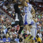 Phoenix Suns' guard Archie Goodwin, left, puts up a shot against Golden State Warriors' Lance Goulbourne in the third quarter of the NBA Summer League championship game, Monday, July 22, 2013, in Las Vegas. The Warriors won 91-77. (AP Photo/Julie Jacobson)
