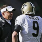 New Orleans Saints head coach Sean Payton, left, talks with quarterback Drew Brees before an NFC divisional playoff NFL football game against the Seattle Seahawks in Seattle, Saturday, Jan. 11, 2014. (AP Photo/John Froschauer)