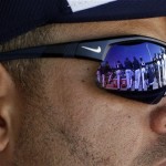 Players are reflected in the sun glasses of Milwaukee Brewers' Aramis Ramirez during a spring training baseball workout, Friday, Feb. 22, 2013, in Phoenix. (AP Photo/Morry Gash)