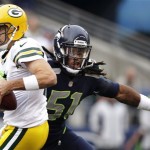 Green Bay Packers quarterback Aaron Rodgers, left, is sacked by Seattle Seahawks defensive end Bruce Irvin (51) in the first half of an NFL football game, Monday, Sept. 24, 2012, in Seattle. (AP Photo/Stephen Brashear)