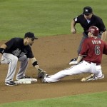 Arizona Diamondbacks' Stephen Drew is tagged out while trying to stretch a single into a double by Florida Marlins' Omar Infante, left, during the first inning of a baseball game, Wednesday, June 1, 2011, in Phoenix. (AP Photo/Matt York)