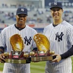 New York Yankees second baseman Robinson Cano, left, and first baseman Mark Teixeira pose with their 2012 Gold Glove awards before a baseball game against the Arizona Diamondbacks at Yankee Stadium in New York, Wednesday, April 17, 2013. (AP Photo/Kathy Willens)
