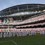 The Arizona Diamondbacks and San Francisco Giants line up for player announcements prior to an opening day baseball game, Friday, April 6, 2012, in Phoenix. (AP Photo/Matt York)