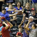 Fans reach for a home run ball hit by Arizona Diamondbacks' Aaron Hill during the sixth inning of a baseball game against the Los Angeles Dodgers, Tuesday, Sept. 17, 2013, in Phoenix. (AP Photo/Matt York)