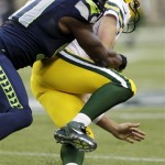 Seattle Seahawks defensive end Chris Clemons, left, sacks Green Bay Packers quarterback Aaron Rodgers in the first half of an NFL football game, Monday, Sept. 24, 2012, in Seattle. (AP Photo/Ted S. Warren)