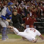 St. Louis Cardinals' David Freese scores in front of Los Angeles Dodgers catcher A.J. Ellis during the third inning of Game 6 of the National League baseball championship series, Friday, Oct. 18, 2013, in St. Louis. (AP Photo/David J. Phillip)