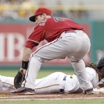 Pittsburgh Pirates' Andrew McCutchen, bottom, dives back to first as Arizona Diamondbacks first baseman Paul Goldschmidt reaches for the pick-off attempt by Diamondbacks starting pitcher Ian Kennedy in the first inning of a baseball game Wednesday, Aug. 8, 2012, in Pittsburgh. (AP Photo/Keith Srakocic)