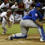 Arizona Diamondbacks' Adam Eaton, left, slides in to score a run ahead of the tag by Chicago Cubs' Dioner Navarro during the sixth inning of a baseball game on Tuesday, July 23, 2013, in Phoenix. (AP Photo/Ross D. Franklin)