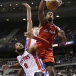 Los Angeles Clippers center DeAndre Jordan (6) dunks over Detroit Pistons center Andre Drummond (0) and forward Kyle Singler during the second half of an NBA basketball game in Auburn Hills, Mich., Monday, Jan. 20, 2014. (AP Photo/Carlos Osorio)