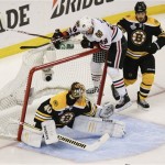 Boston Bruins defenseman Andrew Ference, right, checks Chicago Blackhawks left wing Bryan Bickell (29) into the net as Bruins goalie Tuukka Rask (40), of Finland, defends the goal during the first period in Game 6 of the NHL hockey Stanley Cup Finals, Monday, June 24, 2013, in Boston. (AP Photo/Charles Krupa)
