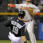 Colorado Rockies' Marco Scutaro (19) is forced out at second by Arizona Diamondbacks second baseman Ryan Roberts, top, during the fourth inning of a baseball game on Friday, April 13, 2012, in Denver. (AP Photo/Jack Dempsey)