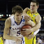 Michigan's Mitch McGary and Kansas' Jeff Withey battle for a rebound during the second half of a regional semifinal game in the NCAA college basketball tournament, Friday, March 29, 2013, in Arlington, Texas. (AP Photo/David J. Phillip)