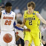 Florida's Michael Frazier II (20) and Michigan's Spike Albrecht (2) go after a loose ball during the second half of a regional final game in the NCAA college basketball tournament, Sunday, March 31, 2013, in Arlington, Texas. (AP Photo/Tony Gutierrez)