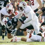 Michigan State tight end Andrew Gleichert, center, is tackled by Stanford cornerback Alex Carter, left, and safety Jordan Richards during the first half of the Rose Bowl NCAA college football game on Wednesday, Jan. 1, 2014, in Pasadena, Calif. (AP Photo/Danny Moloshok)