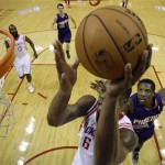  Houston Rockets' Terrence Jones (6) shoots as Phoenix Suns' Channing Frye, right, defends during the first quarter of an NBA basketball game Wednesday, Dec. 4, 2013, in Houston. (AP Photo/David J. Phillip)