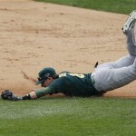 Oakland Athletics shortstop Jed Lowrie dives but is unable to stop the single by Detroit Tigers' Prince Fielder during the sixth inning of Game 3 of an American League baseball division series in Detroit, Monday, Oct. 7, 2013. (AP Photo/Charles Rex Arbogast)