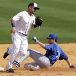Toronto Blue Jays' Josh Thole is forced out at second base by Detroit Tigers second baseman Omar Infante, left, during the third inning of an exhibition spring training baseball game, Saturday, Feb. 23, 2013, in Lakeland, Fla. (AP Photo/Charlie Neibergall)
