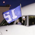 Seattle Seahawks general manager John Schneider waves a "12th Man" flag out of the cockpit as the team arrival Monday, Feb. 3, 2014, at Seattle-Tacoma International Airport in Seattle. The Seahawks beat the Denver Broncos 43-8 in the Super Bowl on Sunday. (AP Photo/Elaine Thompson)