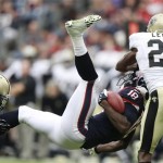 Houston Texans' Lestar Jean (18) is brought down by New Orleans Saints' Keenan Lewis (28) and Kenny Vaccaro (32) during the second half in Houston. (AP Photo/Patric Schneider)