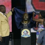 Former NFL football player Warren Sapp, left, and his daughter, Mercedes, unveil Sapp's bust during the induction ceremony at the Pro Football Hall of Fame Saturday, Aug. 3, 2013, in Canton, Ohio. (AP Photo/Tony Dejak)
