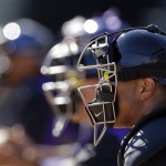 Colorado Rockies' Yorvit Torrealba, right, along with other catchers wait for the pitchers during a spring training baseball workout Tuesday, Feb. 12, 2013, in Scottsdale, Ariz. (AP Photo/Darron Cummings)