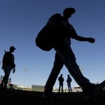 Players for the Chicago White Sox walk off the field after a spring training baseball game against the Texas Rangers on Tuesday, Feb. 26, 2013, in Surprise, Ariz. The White Sox won 14-8. (AP Photo/Charlie Riedel)