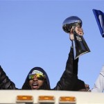 Seattle Seahawks' Richard Sherman holds up the Vince Lombardi Trophy during a parade for the NFL football Super Bowl champions Wednesday, Feb. 5, 2014, in Seattle. The Seahawks defeated the Denver Broncos 43-8 on Sunday. (AP Photo/Elaine Thompson)