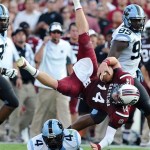 South Carolina quarterback Connor Shaw (14) is tackled by North Carolina cornerback Jabari Price (4) during the first half of an NCAA college football game, Thursday, Aug. 29, 2013, in Columbia, S.C. (AP Photo/Stephen Morton)