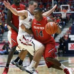  Texas Tech's Robert Turner (14) drives around Arizona's T.J. McConnell, left, in the second half of an NCAA college basketball game on Tuesday, Dec. 3, 2013, in Tucson, Ariz. (AP Photo/John MIller)