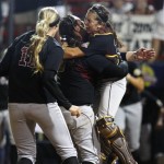 Arizona State catcher Kaylyn Castillo, right, leaps into the arms of pitcher Dallas Escobedo, center, as Krista Donnenwirth, left, runs in from third base, as Arizona State defeats Florida 7-2 in the seventh inning of a Women's College World Series championship series game, to win the national title, in Oklahoma City, Tuesday, June 7, 2011. (AP Photo/Sue Ogrocki)