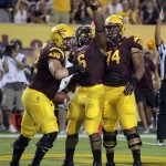  Arizona State running back Cameron Marshall, center, celebrates with Evan Finkenberg, left, and Jamil Douglas after scoring a first quarter touch down against Northern Arizona during their NCAA college football game on Thursday, Aug. 30, 2012, in Tempe, Ariz. (AP Photo/Rick Scuteri)