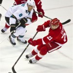 San Jose Sharks forward Joe Pavelski (8) pursues Detroit Red Wings forward Tomas Tatar (21) with the puck, during the second period of an NHL hockey game in Detroit, Mich., Monday, Oct. 21, 2013. (AP Photo/Tony Ding)