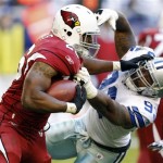 Arizona Cardinals running back Beanie Wells (26) stiff-arms Dallas Cowboys outside linebacker Anthony Spencer (93) during the first half of an NFL football game, Sunday, Dec. 4, 2011, in Glendale, Ariz. (AP Photo/Paul Connors)