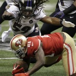 Baltimore Ravens linebacker Dannell Ellerbe (59) tries to tackle San Francisco 49ers running back Frank Gore (21) during the first half of the NFL Super Bowl XLVII football game, Sunday, Feb. 3, 2013, in New Orleans. (AP Photo/Elise Amendola)