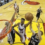 Miami Heat point guard Norris Cole (30) shoots against San Antonio Spurs power forward Tim Duncan, left, and San Antonio Spurs power forward Matt Bonner (15) during the first half of Game 1 of basketball's NBA Finals, Thursday, June 6, 2013 in Miami. (AP Photo/Mike Segar, Pool)